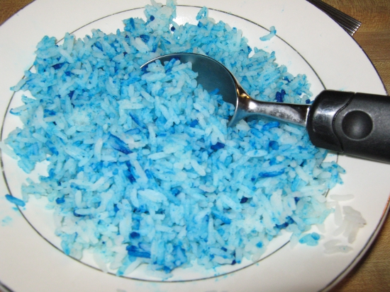 Using an ice cream scooper to shape rice into balls